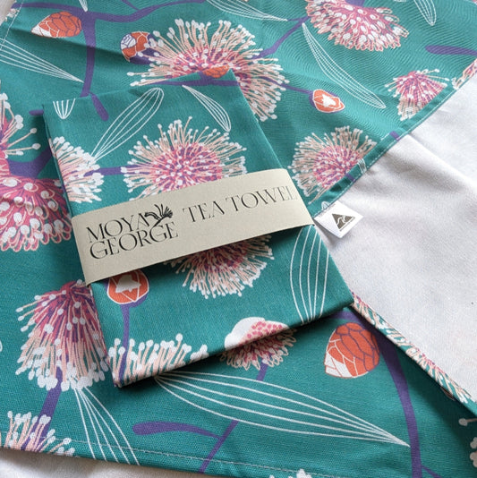Teal floral tea towel with 'Moye George' branding on a white background
