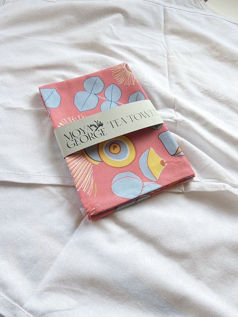 Packaged tea towel with colorful design on a white surface